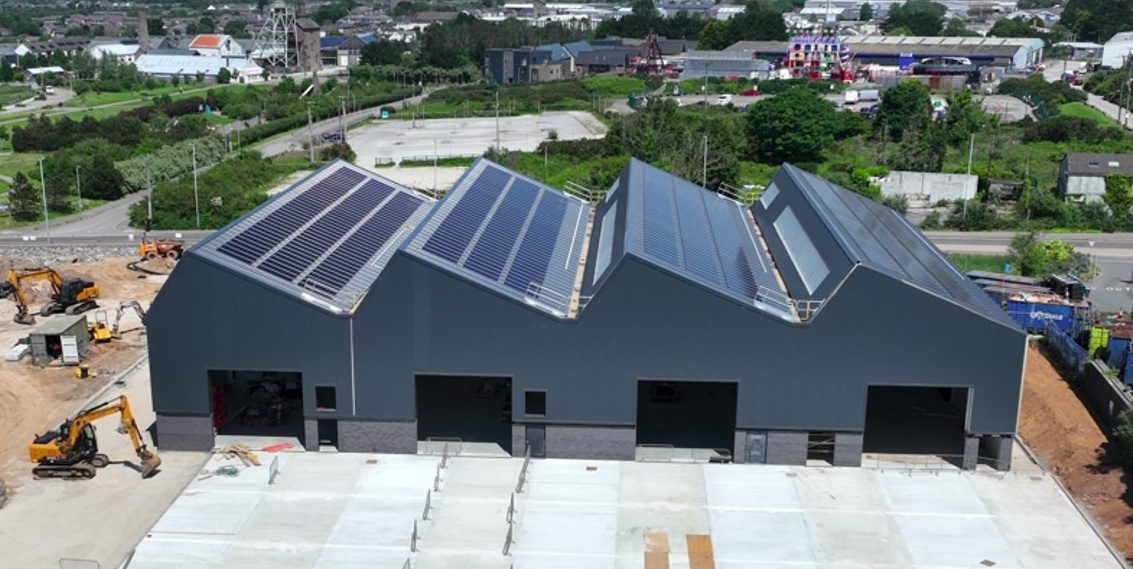 A building with solar panels and cars parked in front of it

AI-generated content may be incorrect.